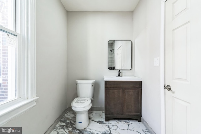 bathroom with vanity, marble finish floor, baseboards, and toilet