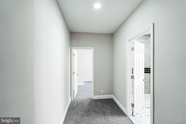 corridor featuring carpet and baseboards