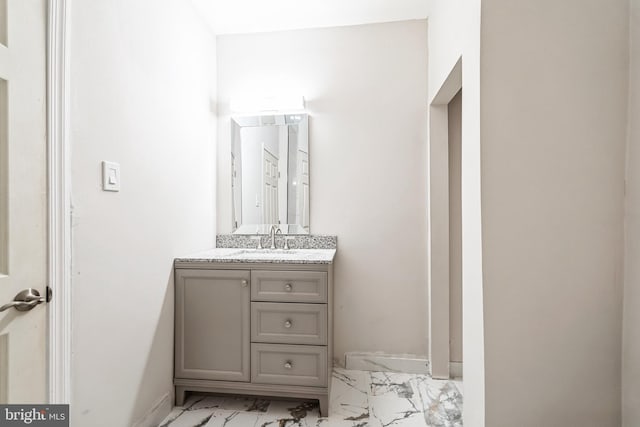 bathroom with marble finish floor and vanity