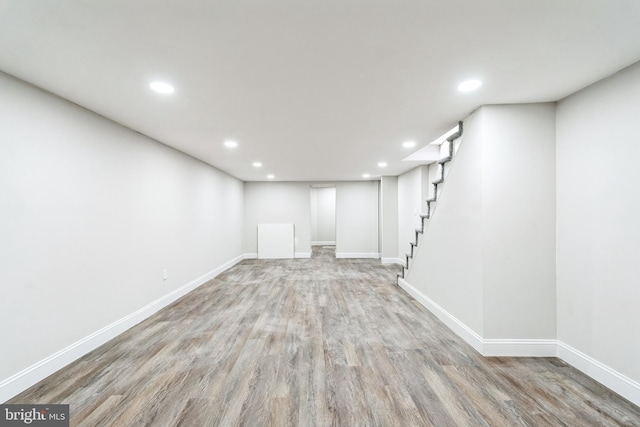 finished basement with baseboards, recessed lighting, and wood finished floors