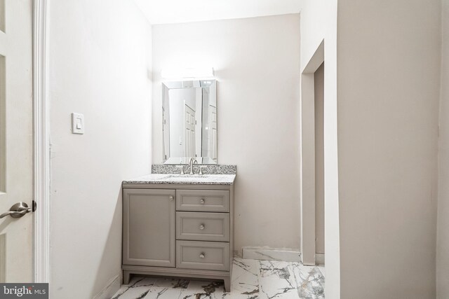 bathroom with marble finish floor and vanity