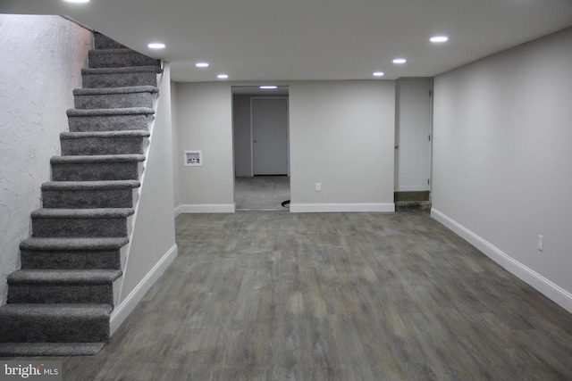 finished below grade area with wood finished floors, baseboards, recessed lighting, and stairs