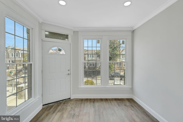 foyer entrance with ornamental molding, baseboards, recessed lighting, and wood finished floors
