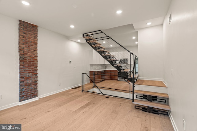 wine cellar with baseboards, light wood finished floors, visible vents, and recessed lighting