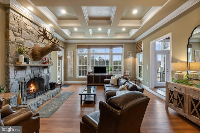 living room featuring wood finished floors, coffered ceiling, a fireplace, crown molding, and beamed ceiling