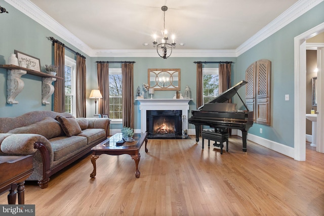 sitting room featuring a lit fireplace, ornamental molding, an inviting chandelier, and wood finished floors