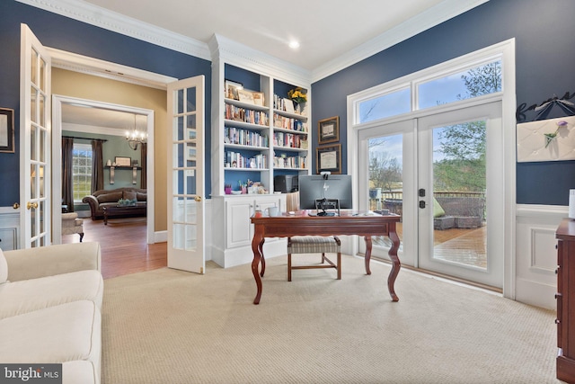 carpeted office featuring built in features, french doors, an inviting chandelier, and ornamental molding