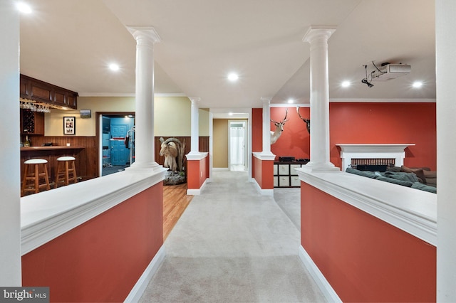 welcome area featuring bar, a fireplace, and decorative columns