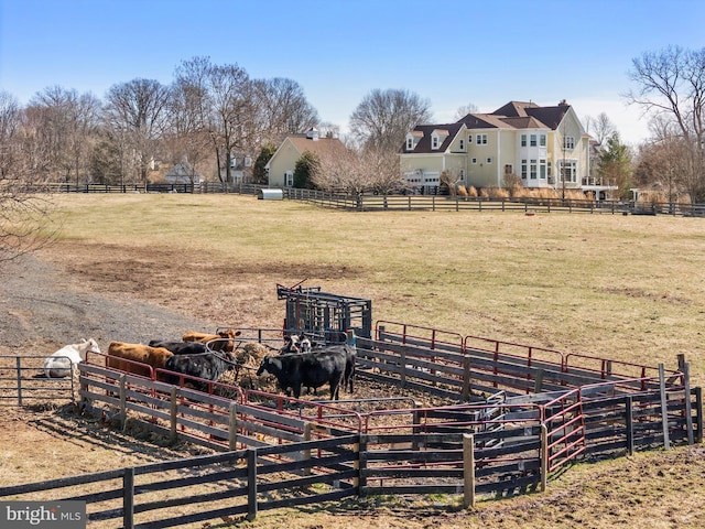 view of yard with a rural view and fence