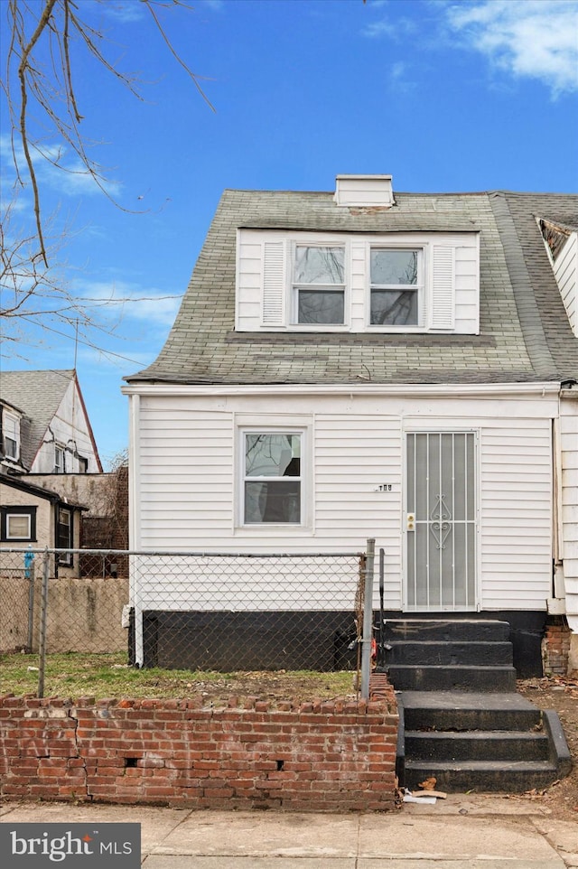 view of front of property featuring entry steps and fence