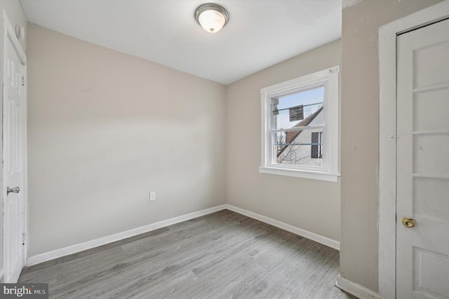 unfurnished bedroom with wood finished floors and baseboards