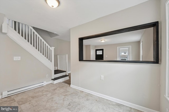 empty room with stairs, baseboard heating, and baseboards