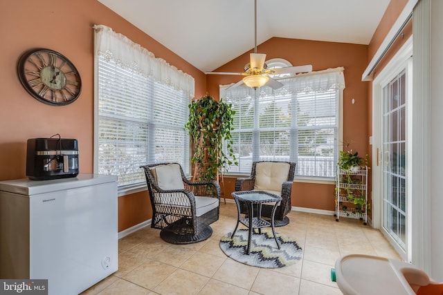 sitting room with lofted ceiling, light tile patterned floors, ceiling fan, and baseboards