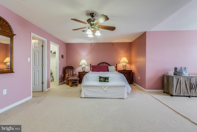 carpeted bedroom featuring ceiling fan, a spacious closet, and baseboards