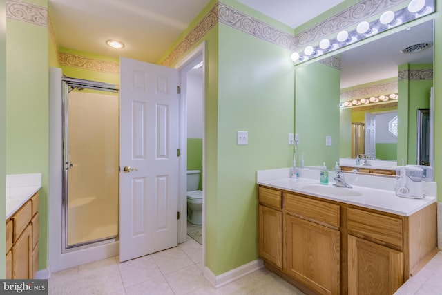 bathroom featuring visible vents, toilet, tile patterned floors, vanity, and a shower stall