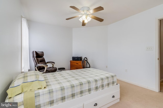 bedroom featuring a ceiling fan, light carpet, and baseboards