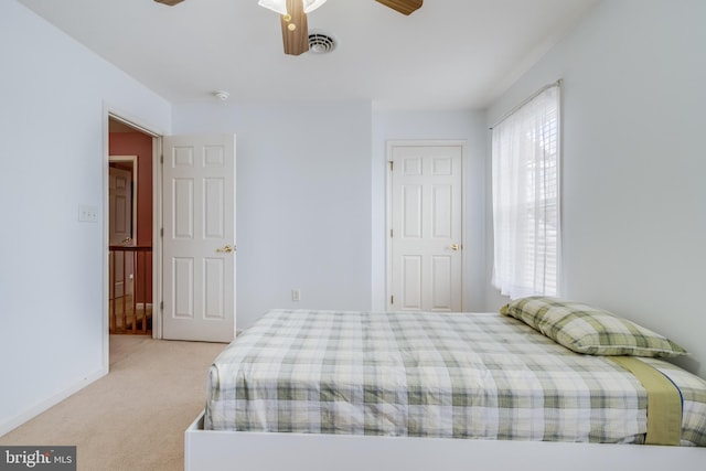 carpeted bedroom featuring visible vents, ceiling fan, and baseboards