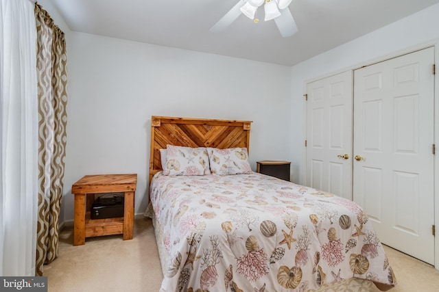 carpeted bedroom featuring a closet and ceiling fan