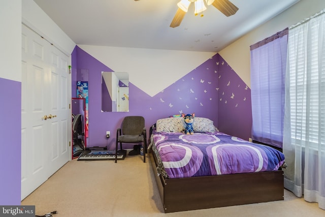 carpeted bedroom with lofted ceiling and a ceiling fan