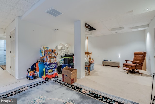 interior space with baseboards, carpet, visible vents, and a drop ceiling