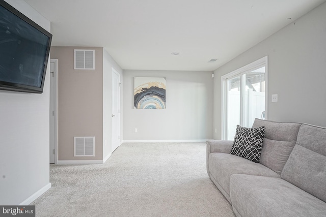 living room featuring visible vents, baseboards, and carpet floors