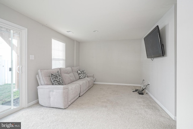 living room featuring carpet flooring, visible vents, and baseboards