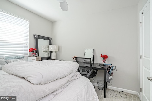 bedroom with a ceiling fan, baseboards, and carpet floors