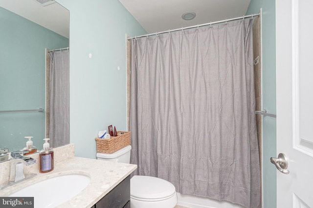 bathroom with toilet, vanity, and shower / tub combo