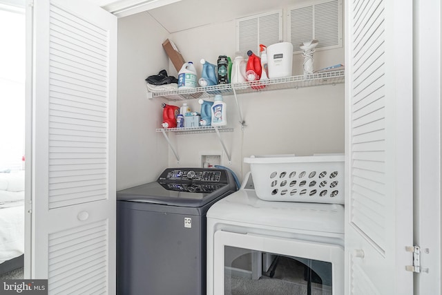 laundry room with separate washer and dryer and laundry area