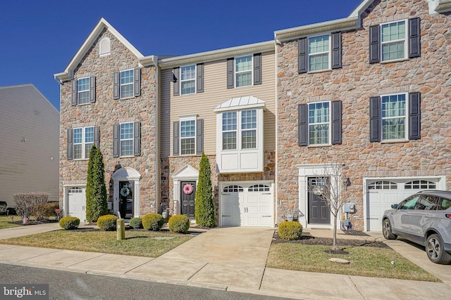 view of property with driveway and a garage