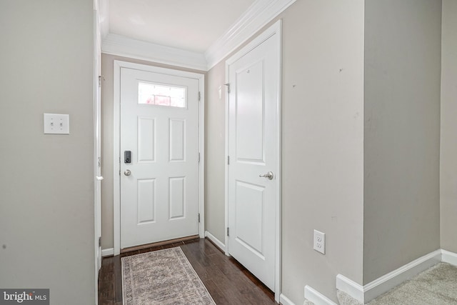 doorway with baseboards, dark wood-style flooring, and ornamental molding