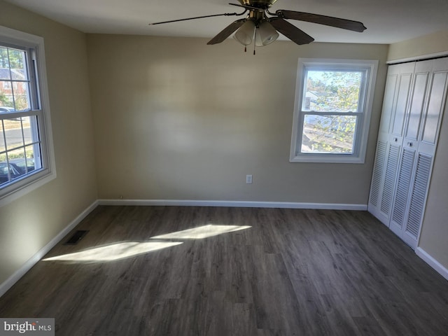 unfurnished bedroom with baseboards, a closet, visible vents, and wood finished floors