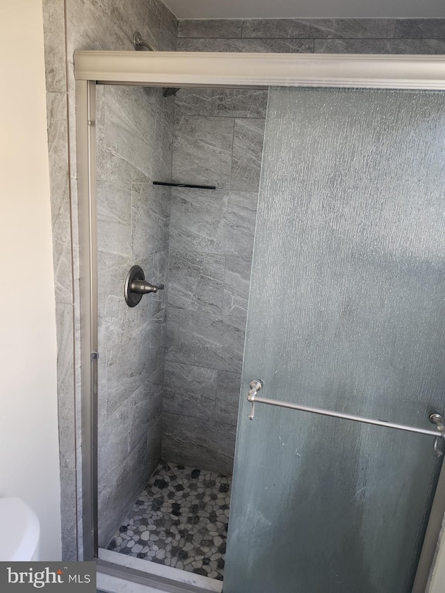 full bath with a shower stall and toilet