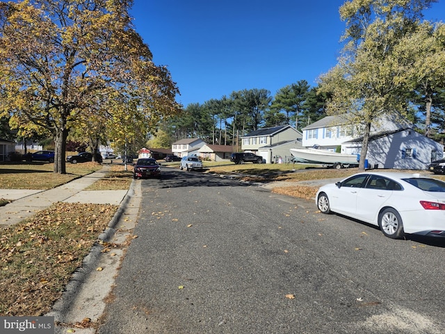 view of street featuring curbs and a residential view