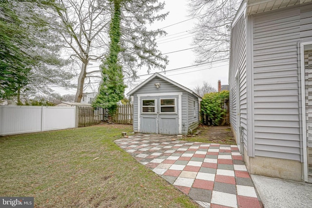 exterior space with a shed, a patio, an outdoor structure, and a fenced backyard