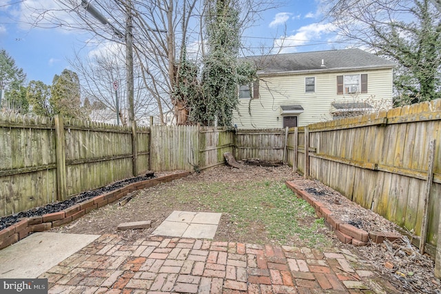 view of yard with a fenced backyard and a patio