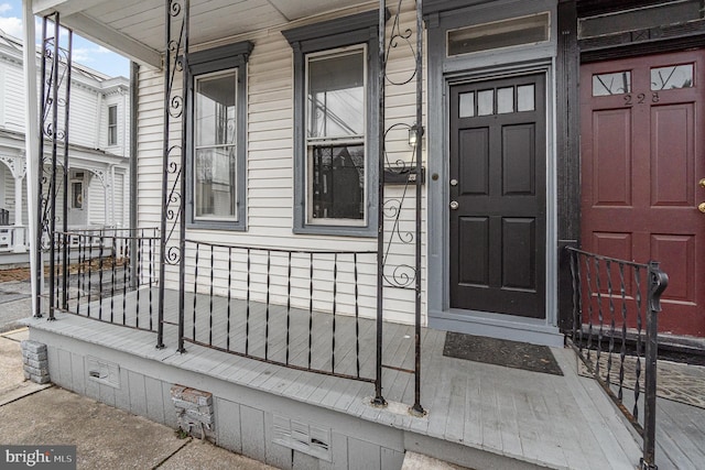 doorway to property with crawl space and a porch