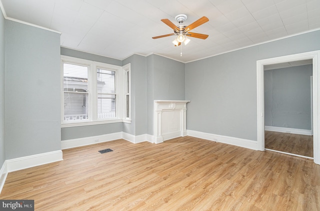 interior space with light wood-type flooring, visible vents, ornamental molding, and baseboards