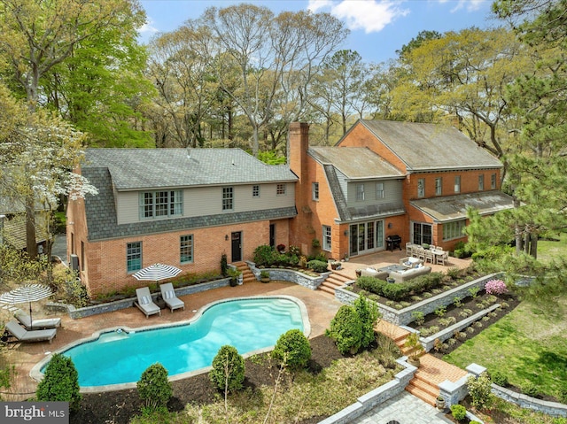 617 Indian Ln, Salisbury, MD 21801 - rear view of property featuring a patio area, brick siding, an outdoor pool, french doors, and a chimney