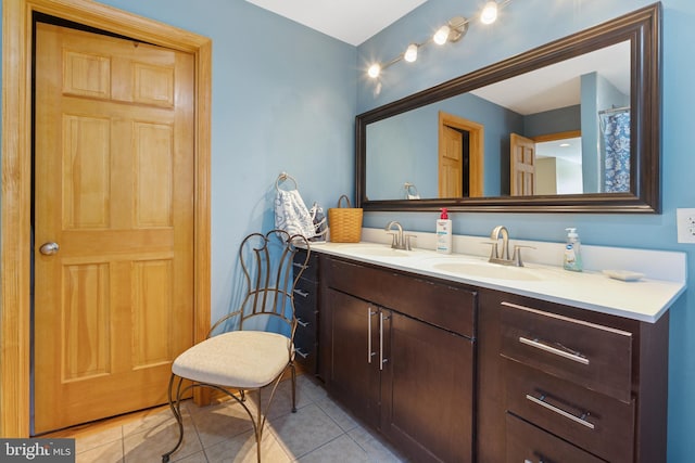bathroom with tile patterned floors, double vanity, and a sink