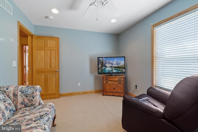 living area with light colored carpet, a ceiling fan, visible vents, recessed lighting, and baseboards