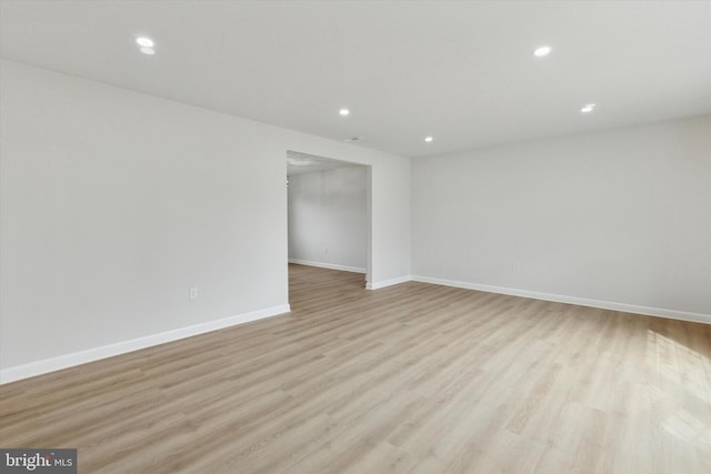 spare room featuring baseboards, light wood-style flooring, and recessed lighting