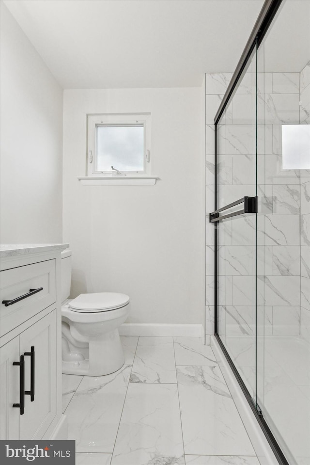 bathroom featuring marble finish floor, baseboards, toilet, and a marble finish shower