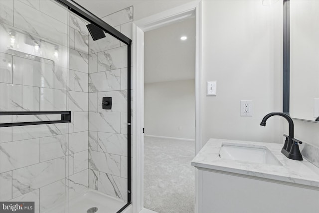 bathroom with a stall shower, vanity, and baseboards