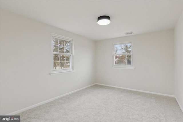 carpeted empty room with baseboards and visible vents