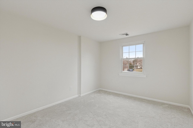 carpeted empty room with baseboards and visible vents