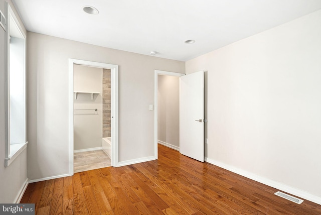 unfurnished bedroom featuring light wood-style floors, recessed lighting, visible vents, and baseboards