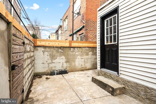 property entrance featuring a patio and fence