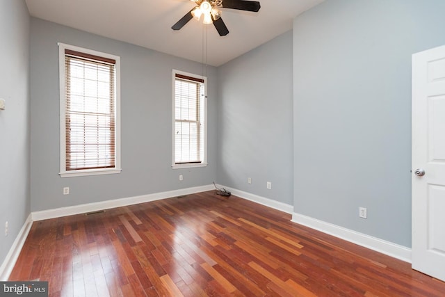 unfurnished room with wood-type flooring, plenty of natural light, and baseboards