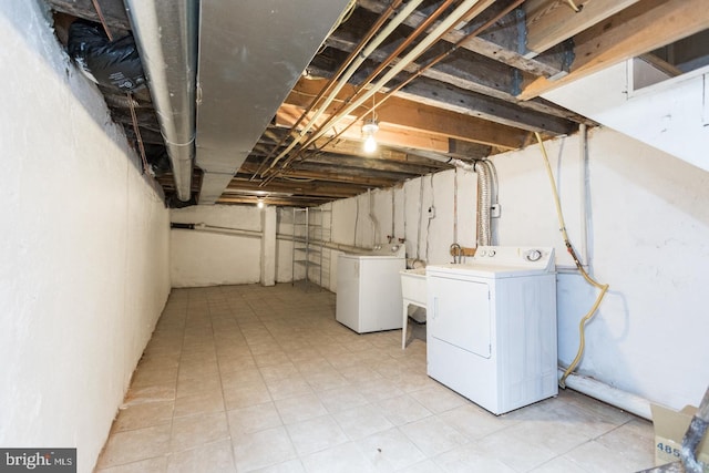 unfinished below grade area featuring washing machine and dryer